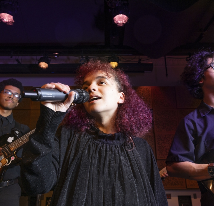Student singing into a microphone
